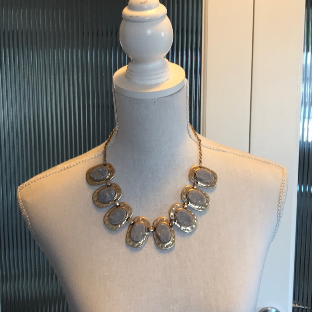 Gold tone and purplish grey gemstone set